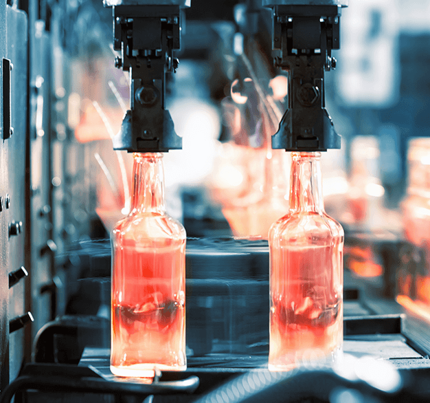Glass gob actively being processed into glass bottles