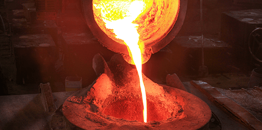 Molten metal stream pours from the ladle into the tundish